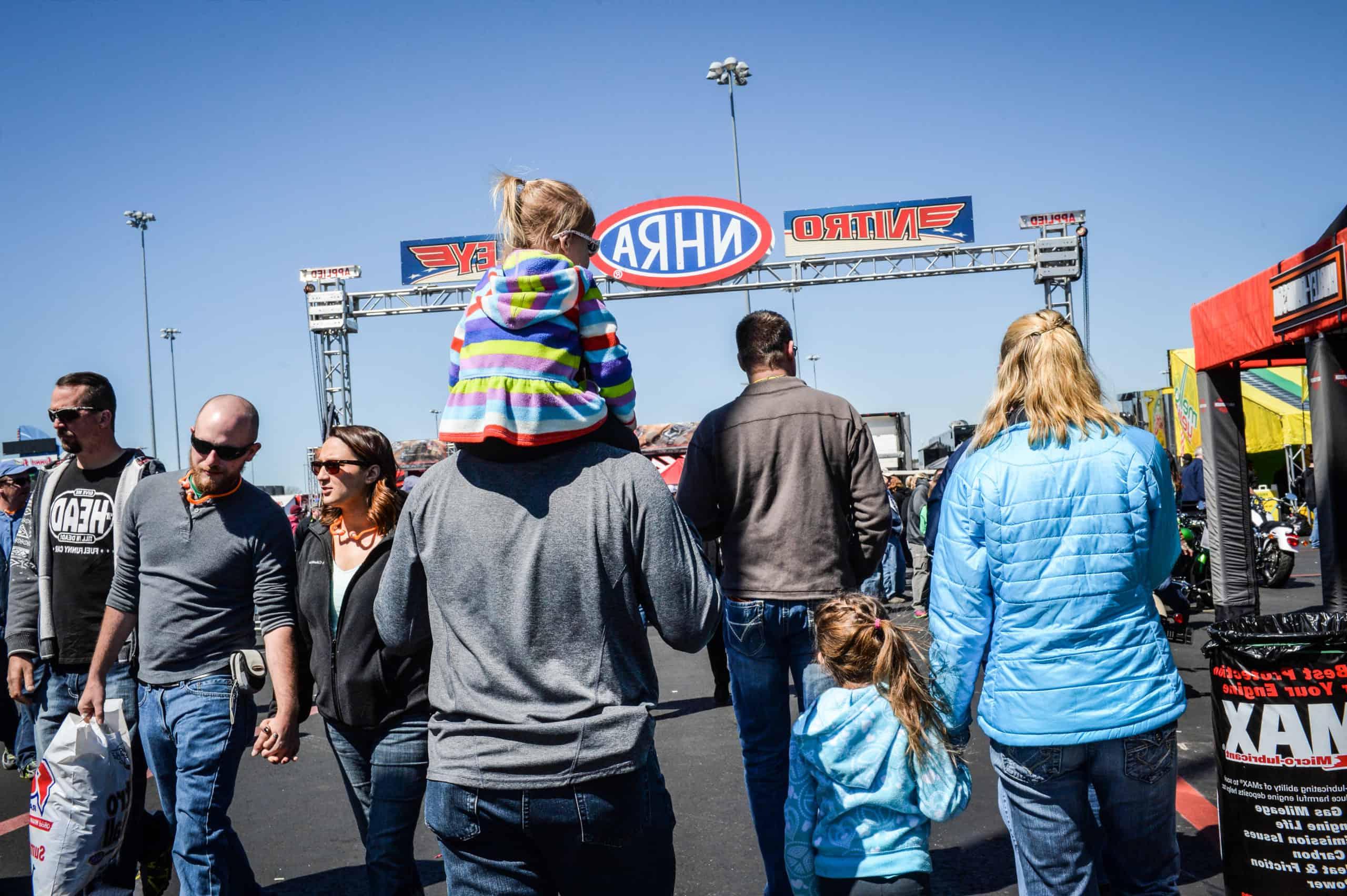 A family enjoys activities in the Nitro Alley Fan Zone at zMAX Dragway