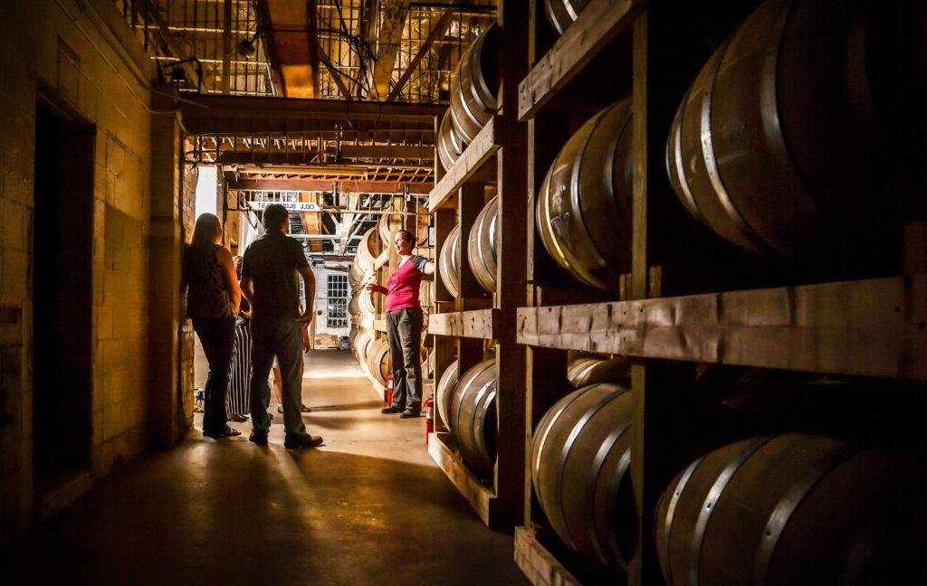 visitors touring distillery